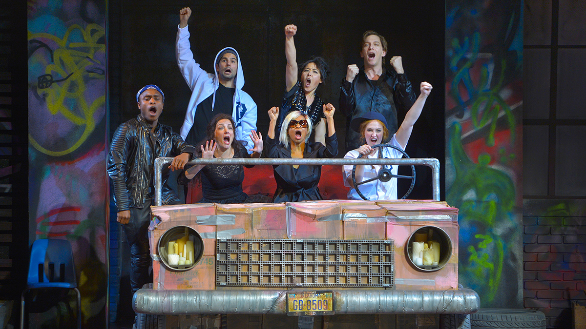 The company of Mr. Burns, a post-electric play rehearses “Chart Hits” in post-apocalyptic Northern California in Anne Washburn’s Mr. Burns, a post-electric play. Photo by Kevin Berne.